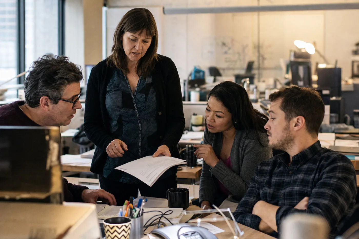 Manager walking a small team through an employee AI policy during a hands-on training session