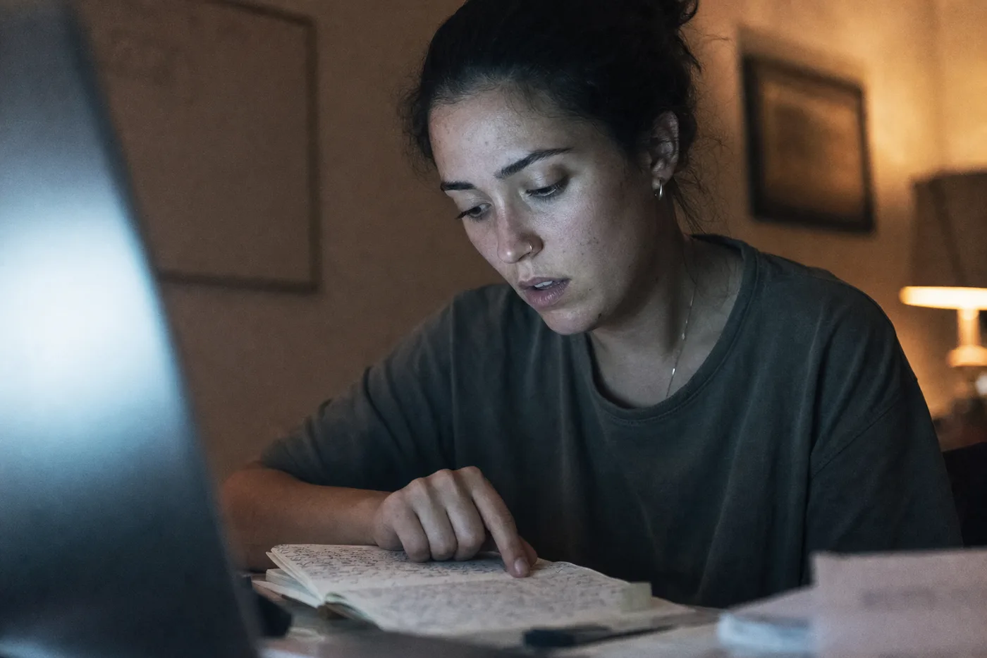An employee catching her own mistake in a notebook during a training session, the moment a Socratic AI tutor is built to create